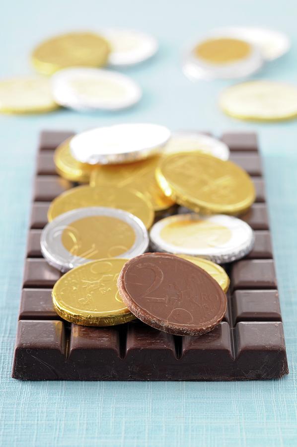 Chocolate Coins And A Bar Of Chocolate Photograph by Jean-christophe Riou