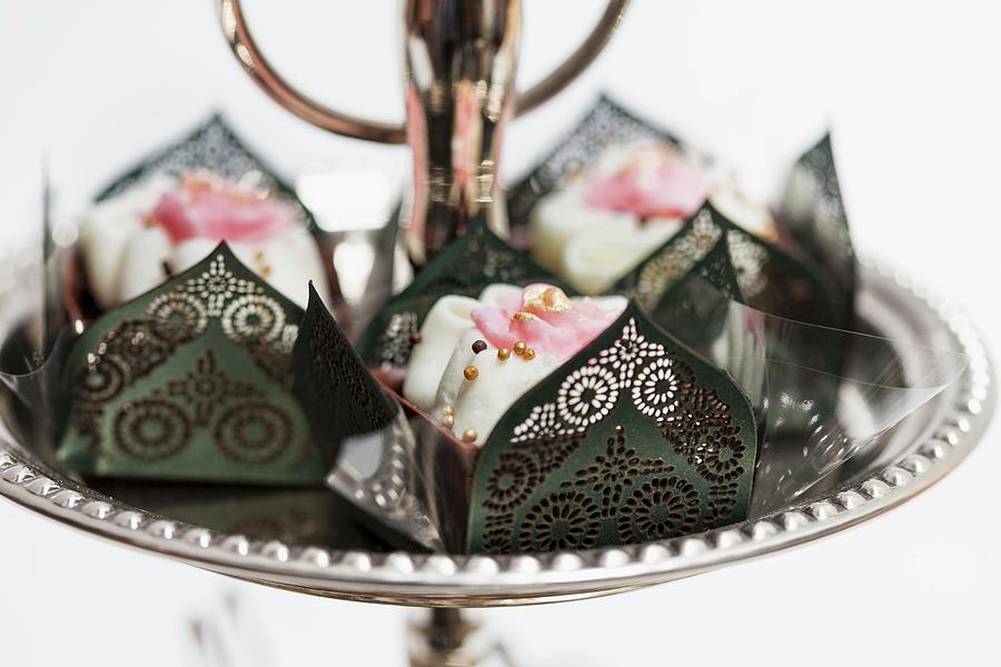 Chocolate Confectionery In Elegant Paper Cases Decorated With Roses And Golden Sugar Pearls Photograph by Karl Stanzel