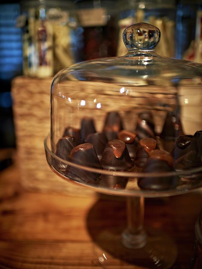 Chocolate Confectionery Under A Glass Cloche Photograph by Hannah Kompanik
