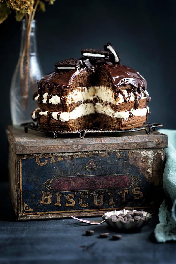 Chocolate Cream Cake With Chocolate Biscuits On An Old Biscuit Tin Photograph by Lucy Parissi
