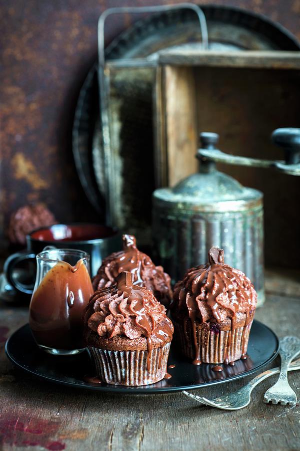 Chocolate Cupcakes Served With Chocolate Sauce Photograph by Irina Meliukh