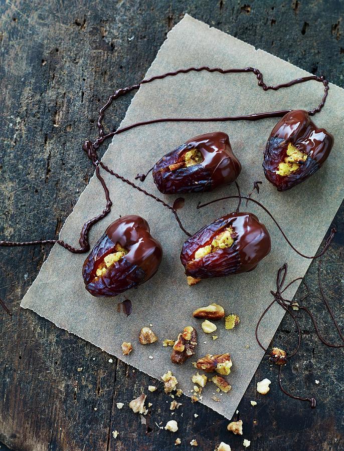 Chocolate Dates Filled With Nuts Photograph by Lars Ranek