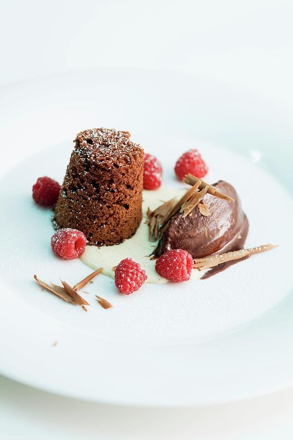 Chocolate Dessert With Raspberry In A Pool Of Cream Photograph by Michael Wissing