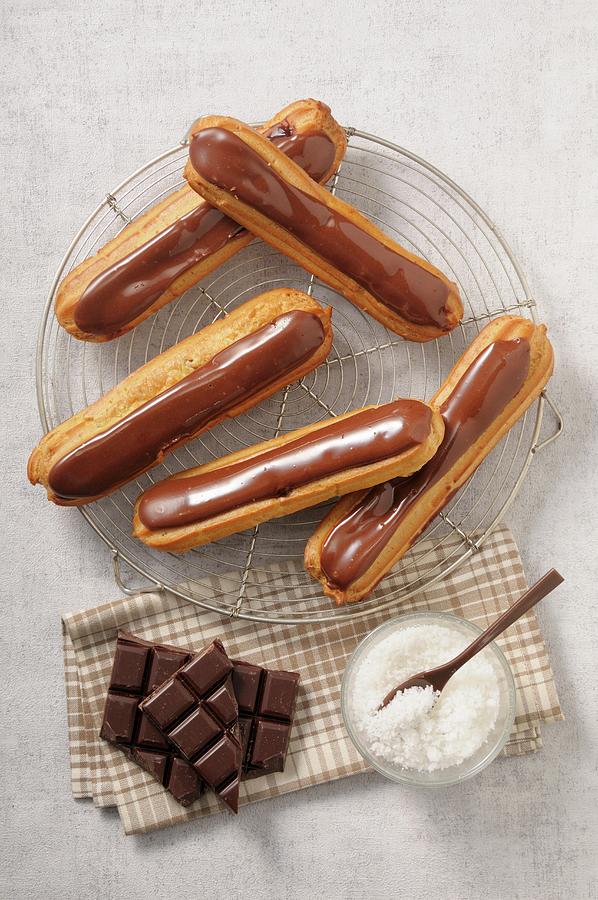 Chocolate Eclairs And Grated Coconut Photograph by Jean-christophe Riou