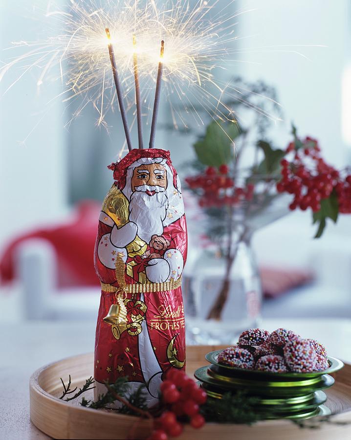 Chocolate Father Christmas Decorated With Sparklers Photograph by Matteo Manduzio