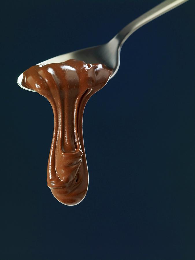 Chocolate Flowing From A Spoon Photograph by Studio R. Schmitz