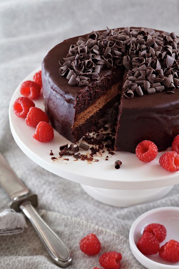 Chocolate Ganache Cake With Chocolate Curls And Raspberries; Slice Removed Photograph by Jon Edwards Photography