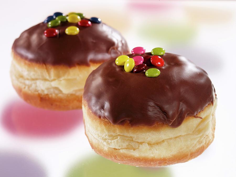 Chocolate Glazed Doughnuts Decorated With Coloured Chocolate Beans Photograph by Albert Fritz