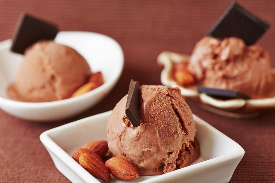 Chocolate Ice Cream With Chocolate Curls And Almonds Photograph by Robert Kneschke