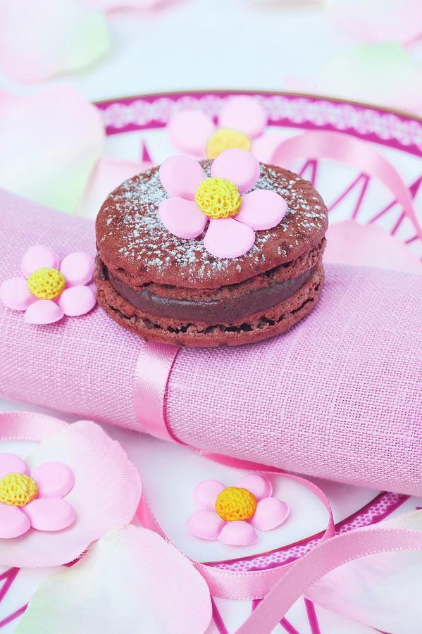 Chocolate Macaroon With Sugar Flowers On A Pink Napkin Photograph by Burgess, Jasmine
