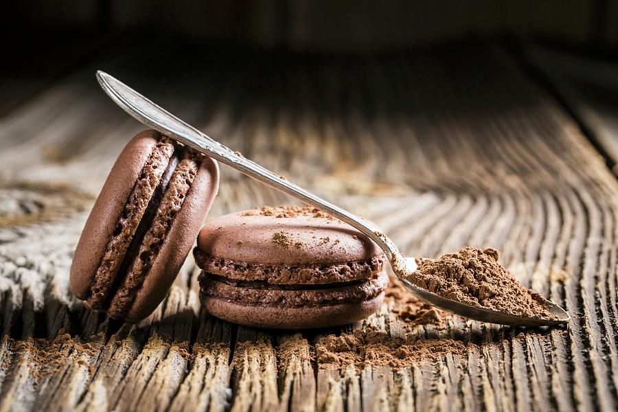 Chocolate Macaroons On A Wooden Table Photograph by Shaiith