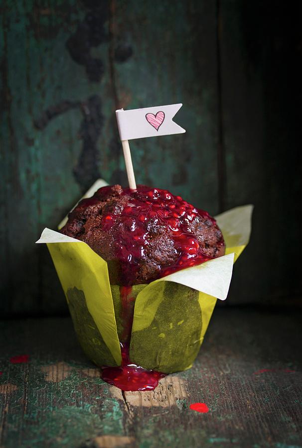 Chocolate Muffin With Raspberry Sauce And Paper Flag Photograph by Valeria Aksakova