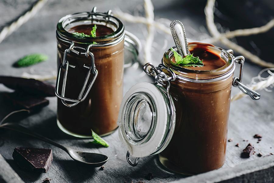 Chocolate Pudding Decorated With Mint Leaves And Dark Chocolate In Glass Jars Photograph by Mateusz Siuta
