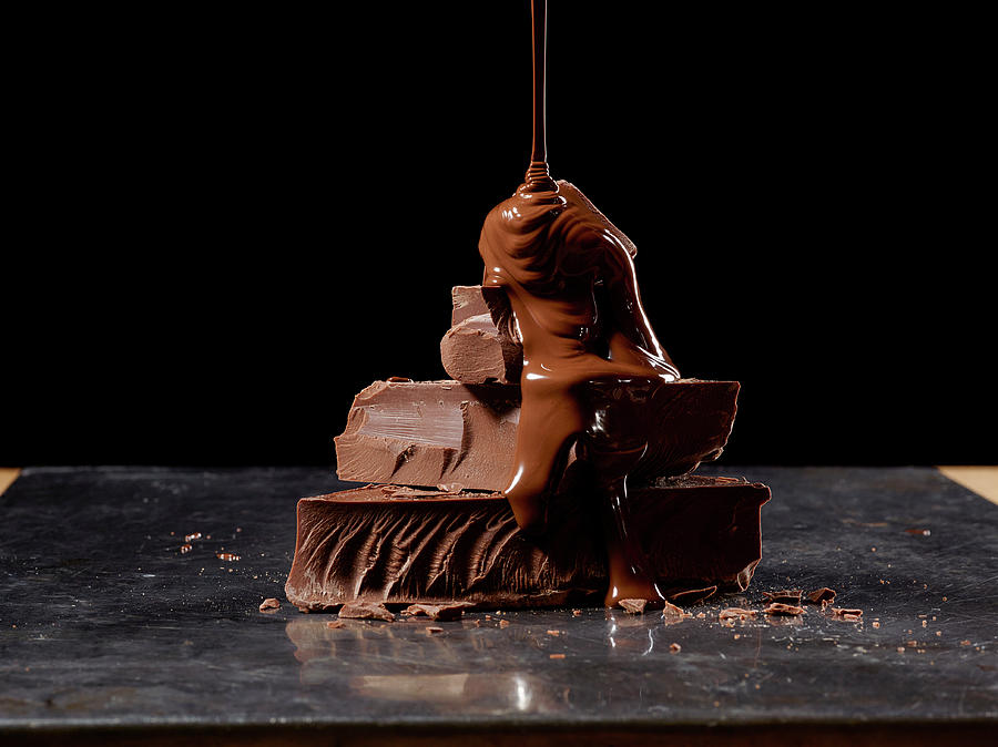 Chocolate Sauce Being Poured On Stack Of Chocolate Photograph by Leo Gong