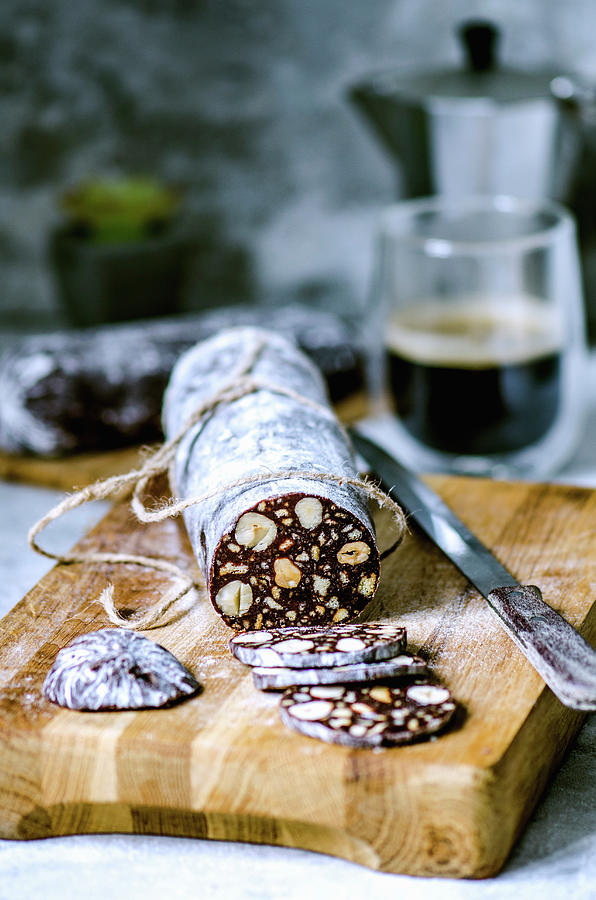 Chocolate Sausage With Biscuits And Hazelnuts, Cut On A Wooden Board Photograph by Gorobina