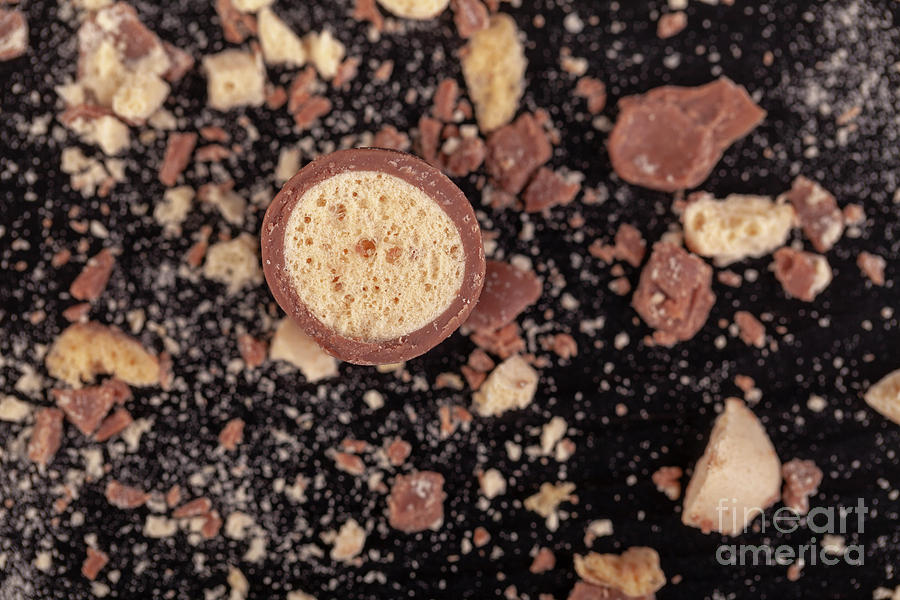 Chocolate sweets broken into crumbs Photograph by Simon Bratt