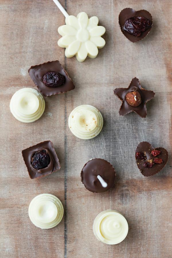 Chocolates On Stick With Homemade Pralines With Dried Fruits Photograph by Mandy Reschke