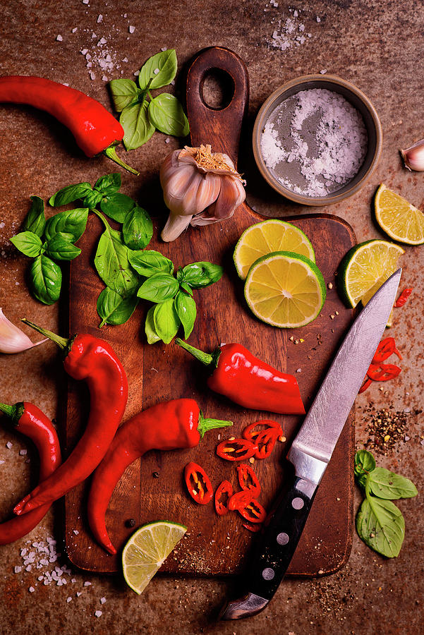 Chopping Board With Knife And Chilli, Basil, Lime, Garlic And Salt Photograph by Karolina Polkowska
