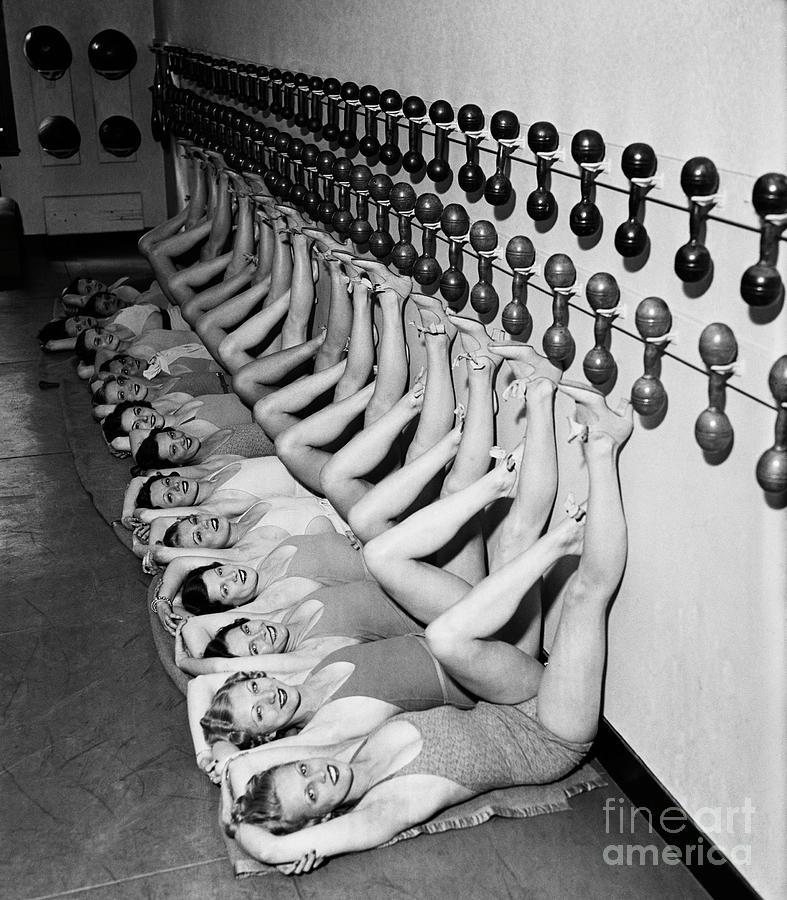 Chorus Girls Doing Leg Exercises At Gym Photograph by Bettmann