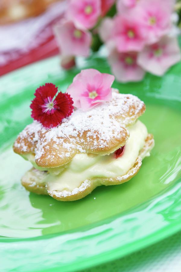 Choux Pastry Filled With Crme Ptissire And Topped With Edible Flowers Photograph by Angelica Linnhoff