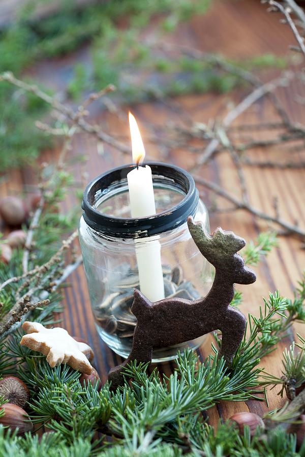 Christmas Arrangement Of Candle In Jam Jar And Reindeer-shaped Biscuit Photograph by Martina Schindler
