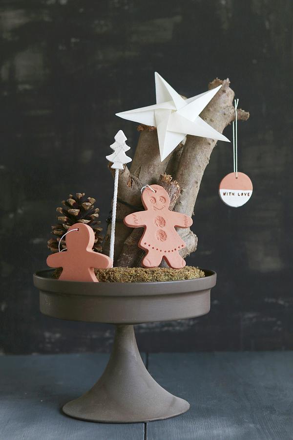 Christmas Arrangement Of Gingerbread Men Made From Clay And Paper Star On Cake Stand Photograph by Regina Hippel