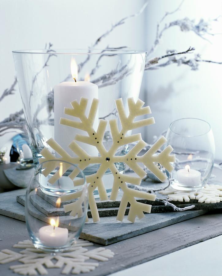 Christmas Arrangement Of White Candles In Various Glass Vessels And Snowflake Ornament Photograph by Matteo Manduzio