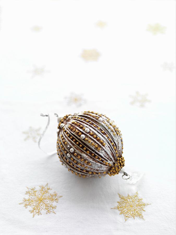 Christmas Bauble Decorated In Silver And Gold Photograph by Shaun Cato-symonds