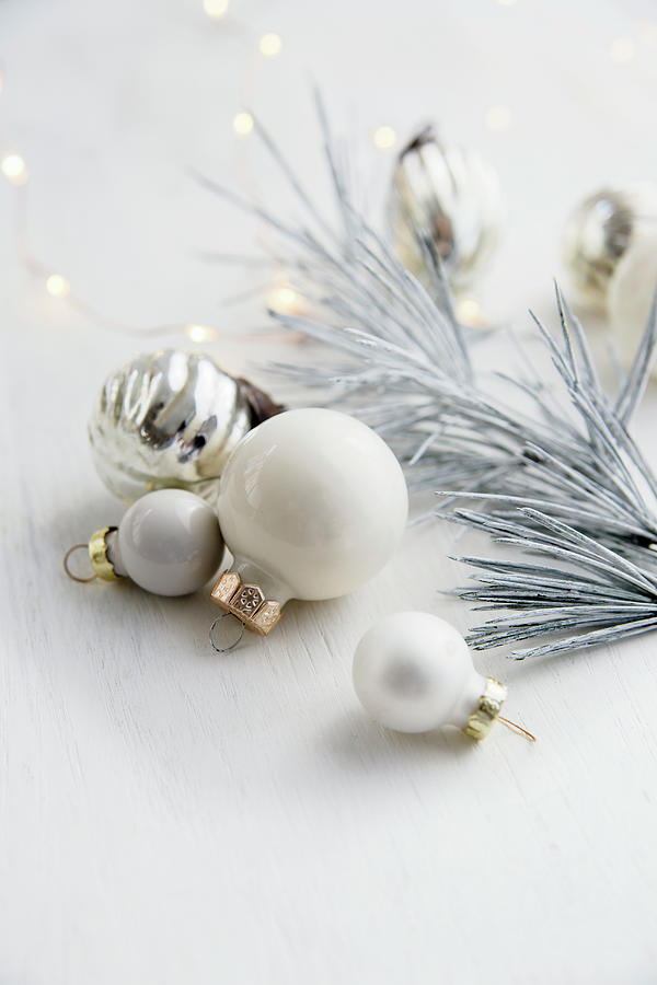 Christmas Bauble Decorations And White Fir Tree With Christmas Lights Photograph by Victoria Firmston