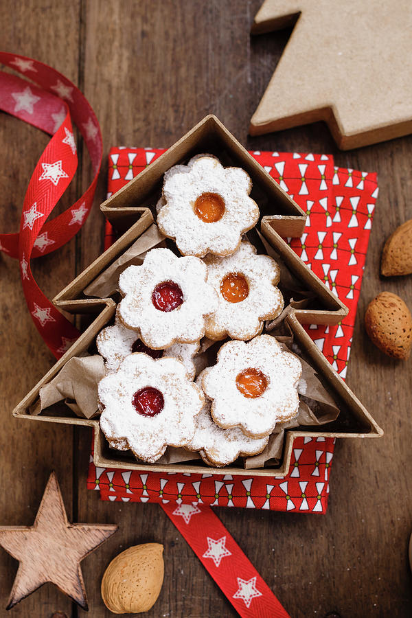 Christmas Biscuits With Red And Yellow Jam In A Tree Shaped Box Photograph by Brigitte Sporrer