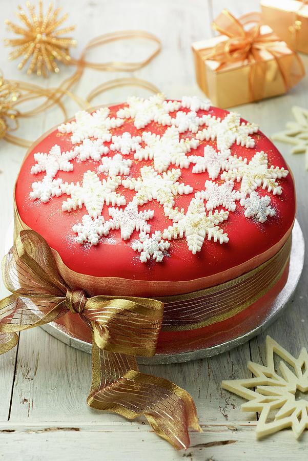 Christmas Cake Decorated With Sugar Snow Flakes And A Gold Ribbon Photograph by Jonathan Short