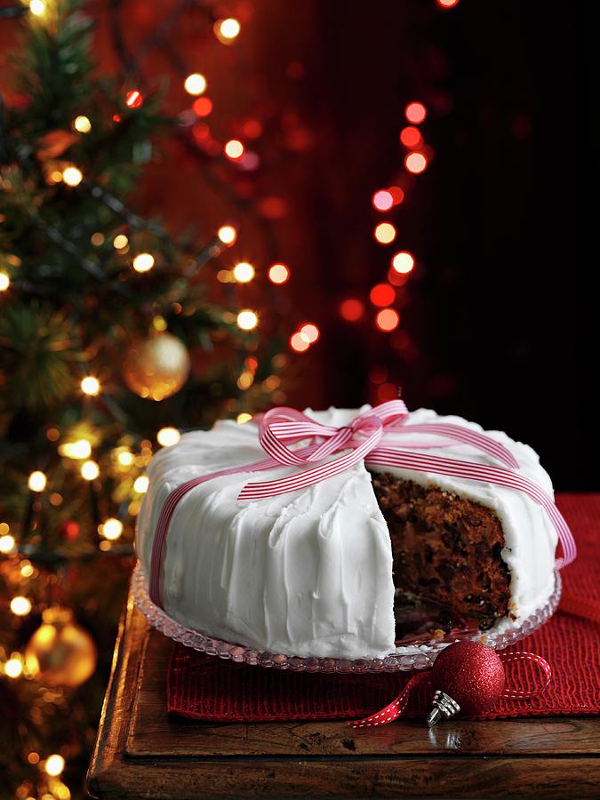 Christmas Cake With A Slice Taken Out Photograph by Gareth Morgans