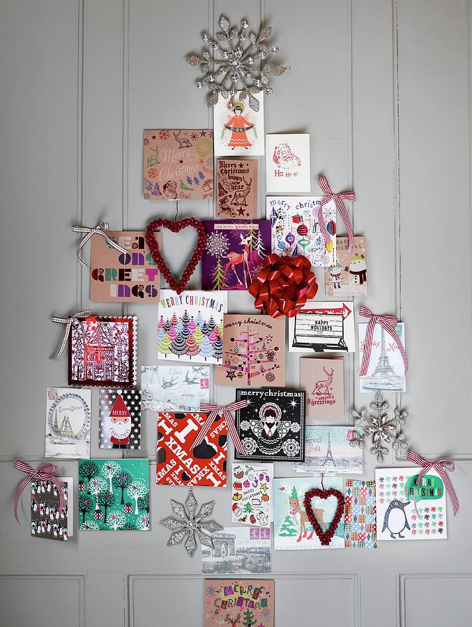 Christmas Cards Arranged On Wall In Fir Tree Shape Photograph by Catherine Gratwicke