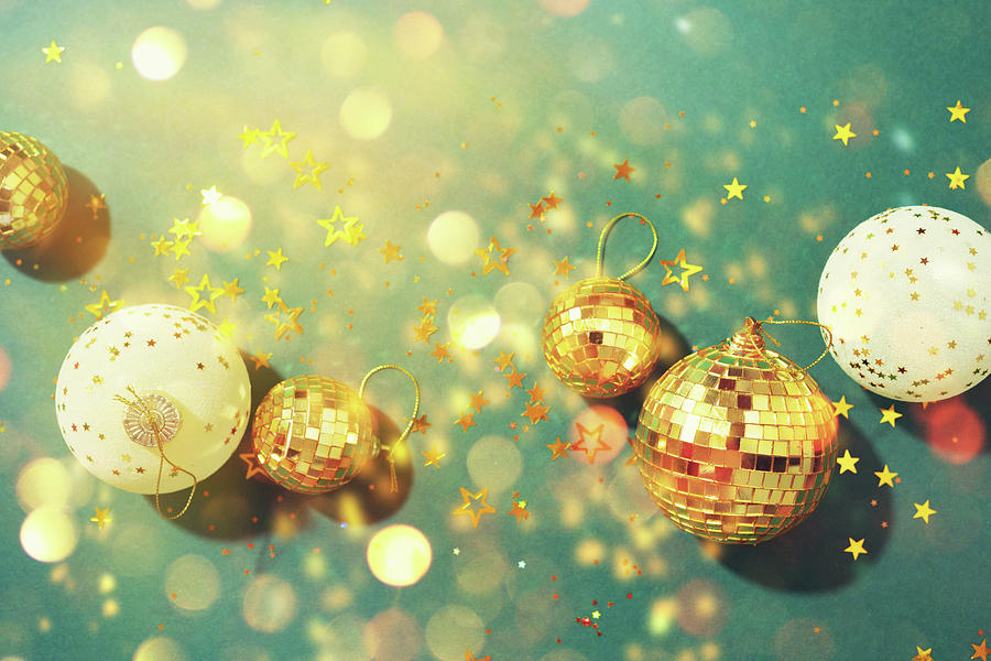 Christmas composition. Flat lay, top view. Disco ball bauble, star  sparkles. Minimal New year party concept. Christmas white and gold  decorations on green background with copy space. Photograph by Yuliia  Chyzhevska 