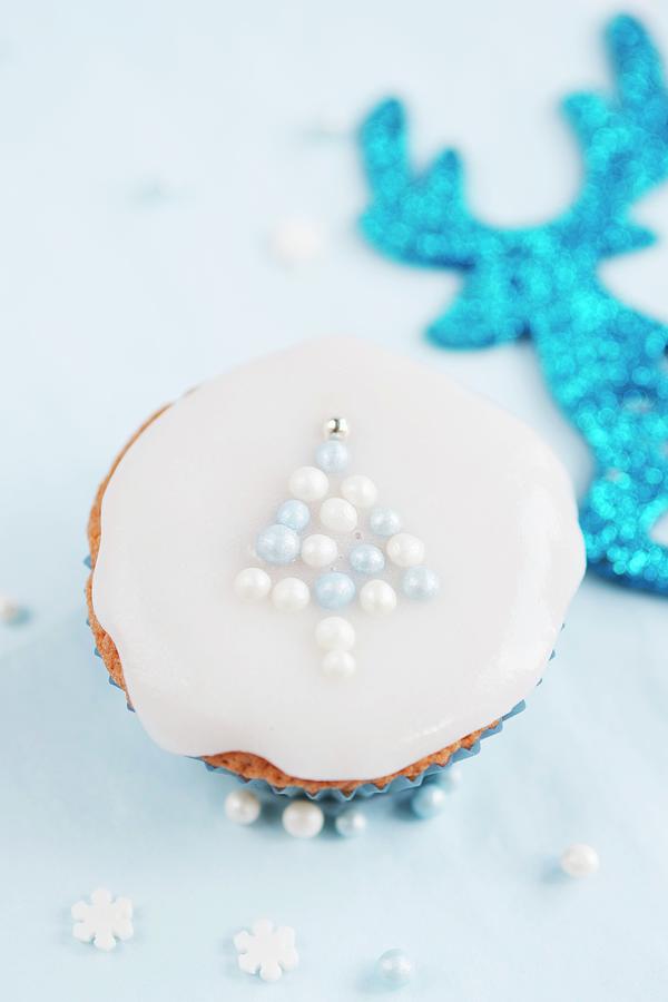 Christmas Cupcake, Decorated With A Christmas Tree Made From Sugar Balls Photograph by Ewa Rejmer