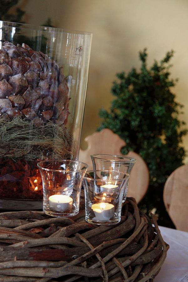 Christmas Decor With Large Fir Cone And Tea Lights Photograph by Anneliese Kompatscher