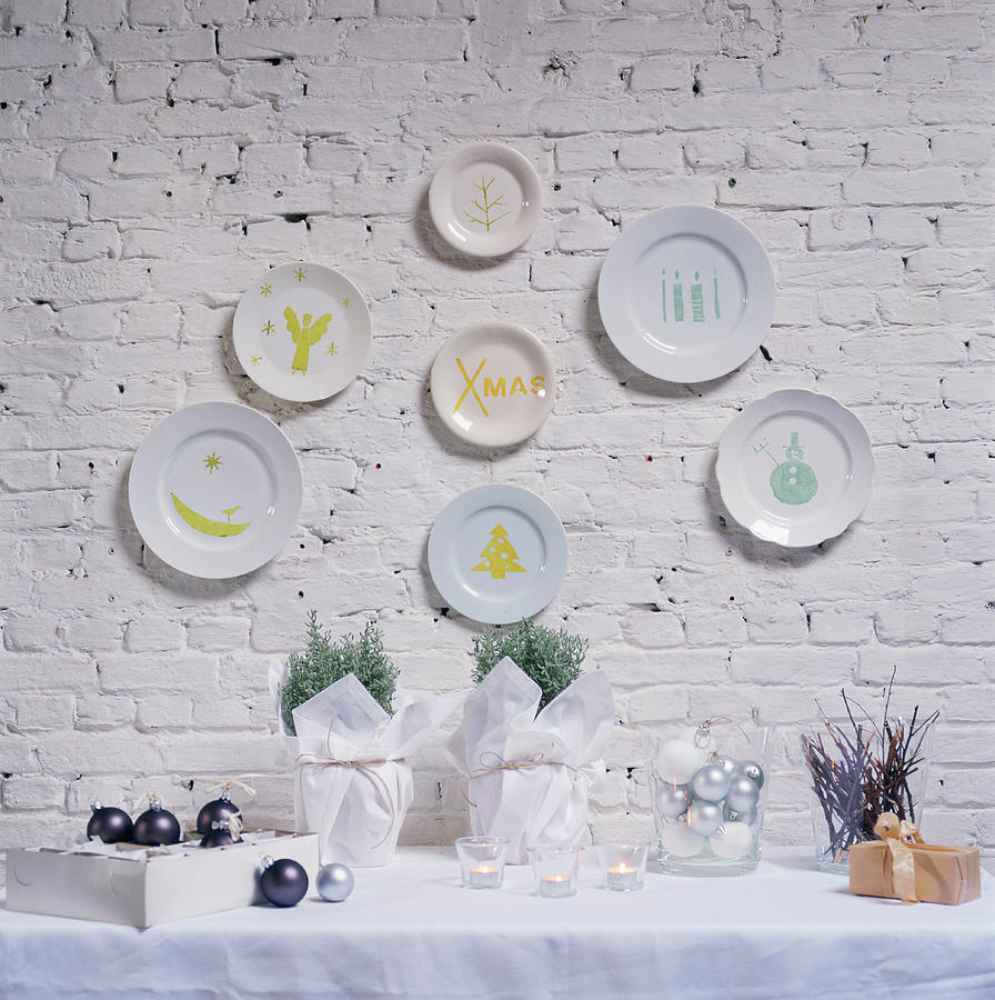 Christmas Decoration On A Table And Hand-painted Plates On A Wall Photograph by Michele Francken