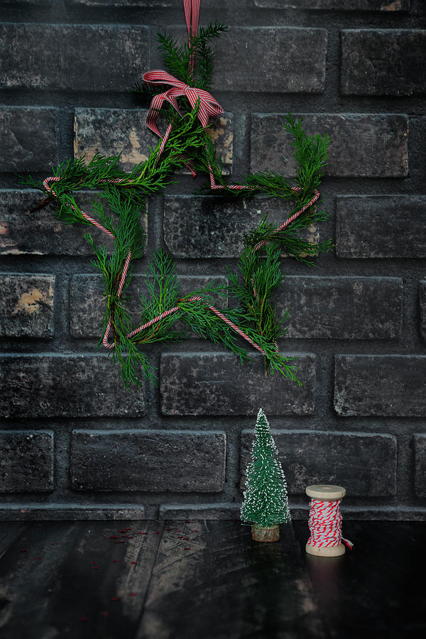Christmas Decoration On Dark Brick Wall Photograph by Claudia Gargioni