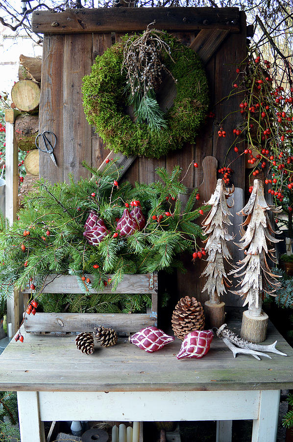 Christmas Decoration With A Moss Wreath, Box With Branches, Wooden Decorative Trees, And Rose Hips Photograph by Christin By Hof 9
