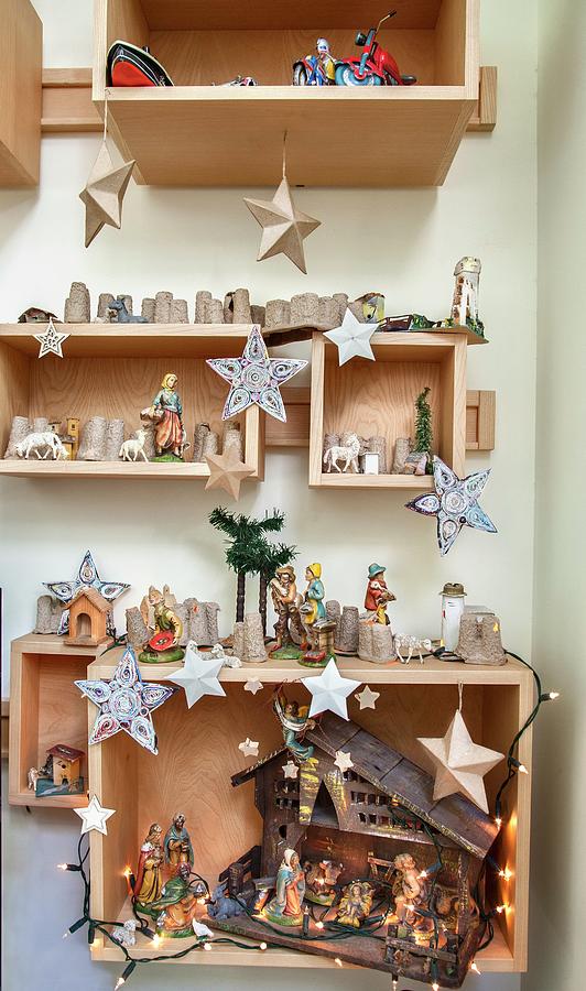 Christmas Decorations And Nativity Scene In Wooden Boxes On Wall Photograph by Laura Rizzi