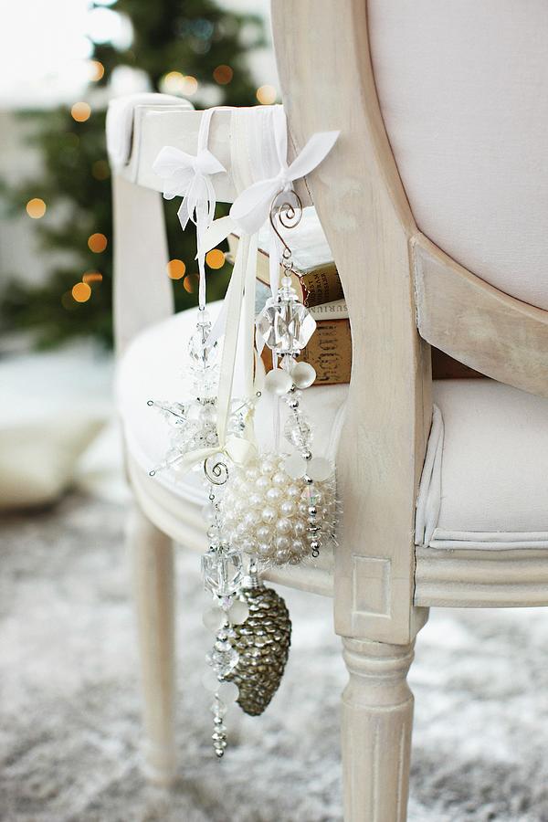 Christmas Decorations Hanging From Rococo Chair Photograph by Biglife