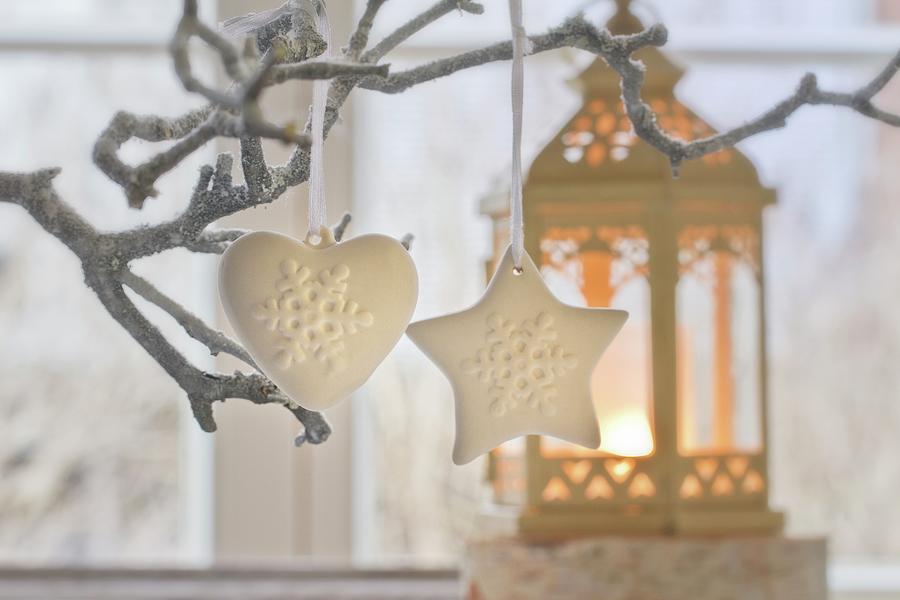 Christmas Decorations Hanging On Tree And Candlelit Lantern Photograph by Uwe Merkel