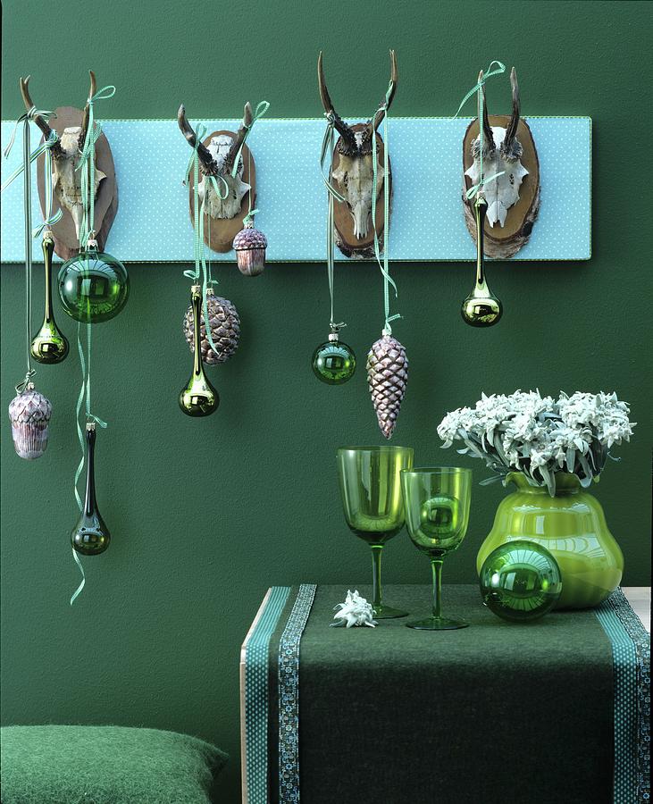 Christmas Decorations In Shades Of Green With Baubles Hanging From Row Of Antlers Photograph by Matteo Manduzio