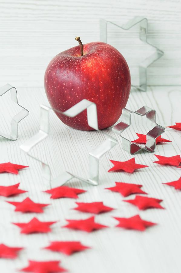 Christmas Decorations, With Cutters, Red Felt Stars And An Apple Photograph by Sass, Achim