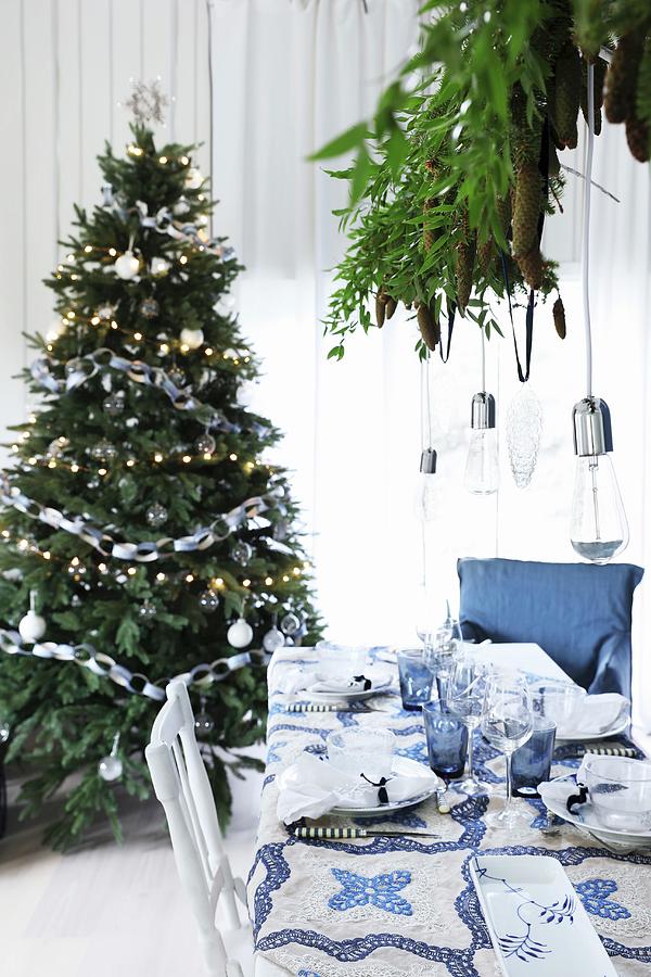 Christmas Dinner Table Set In Blue And White In Front Of Christmas Tree Photograph by Annette Nordstrom