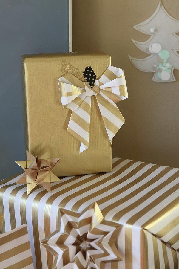 Christmas Gifts Decoratively Wrapped In Gold Paper With Hand-made Bow Photograph by Regina Hippel