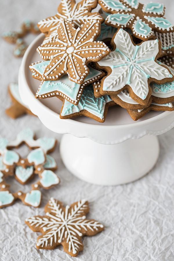 Christmas Gingerbread Biscuits With Coloured Icing On A Cake Stand Photograph by Malgorzata Laniak