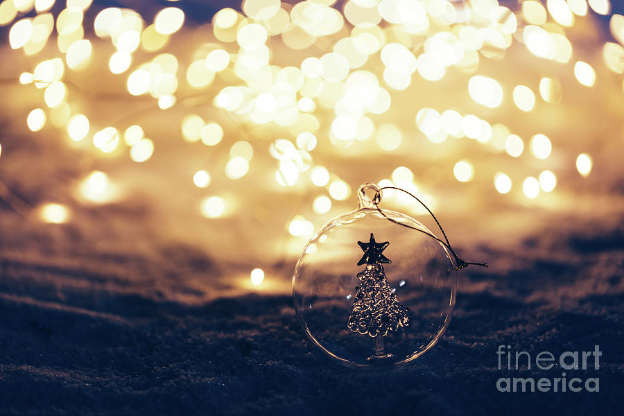 Christmas ornament on snowy illuminated background. Photograph by Michal Bednarek