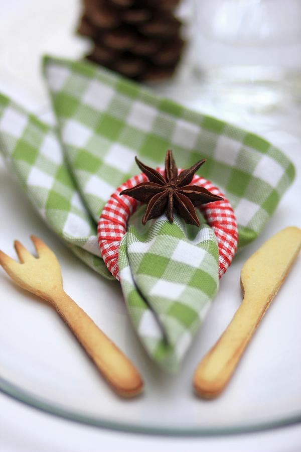 Christmas Place Setting With Linen Napkin, Napkin Ring, Star Anis And Pastry Cutlery Photograph by Ruth Laing