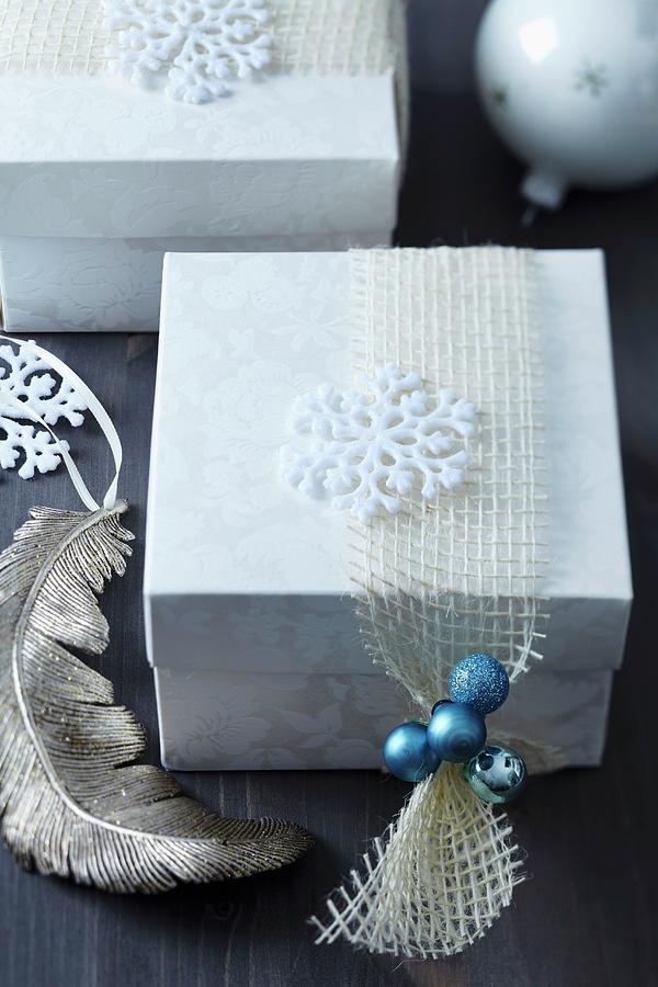 Christmas Present In Gift Box With Stylised Snowflake And Miniature Turquoise Baubles On Net Ribbon Photograph by Franziska Taube